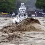 Flood water reaching the head of a statue